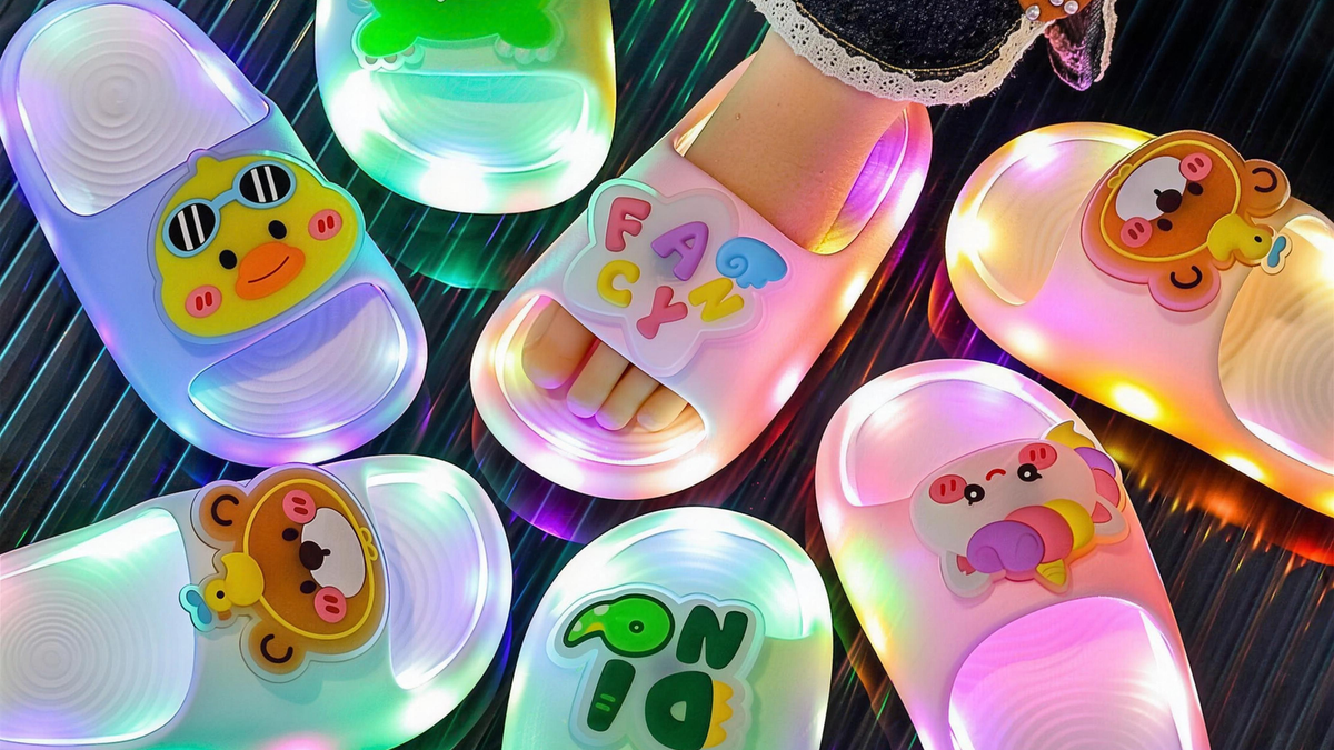 Seven pairs of STEPGLO light-up slides in different colourways, soles glowing
